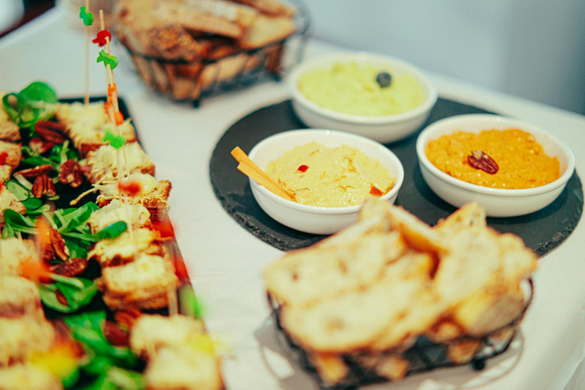 A variety of gourmet dips and appetizers beautifully arranged on a table, inviting for parties or events.