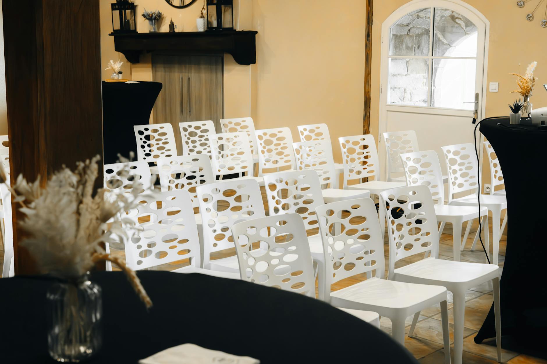 Elegant indoor event setup with modern white chairs, ready for a gathering or conference.